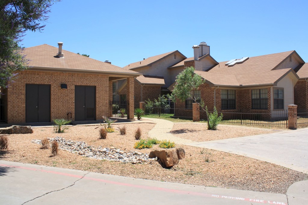 a house with a yard with rocks and plants