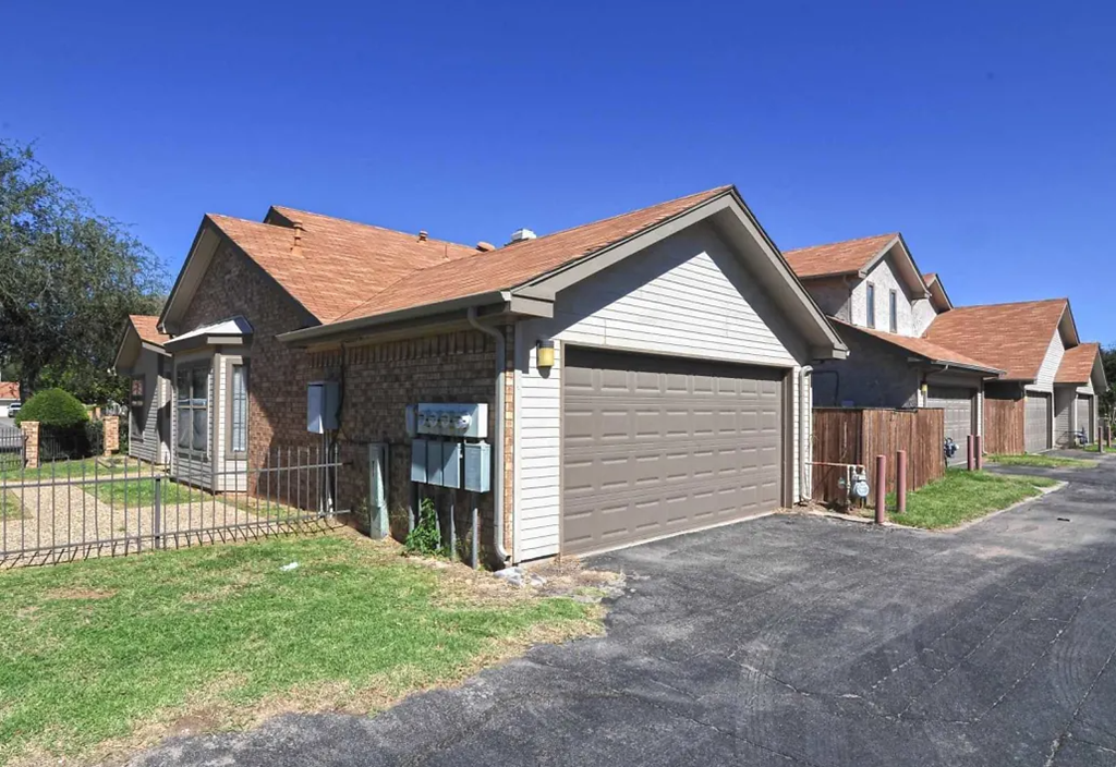 a house with a driveway and a garage door