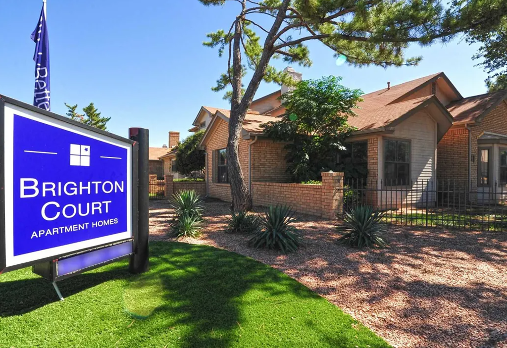 a house with a brighton court sign in front of it