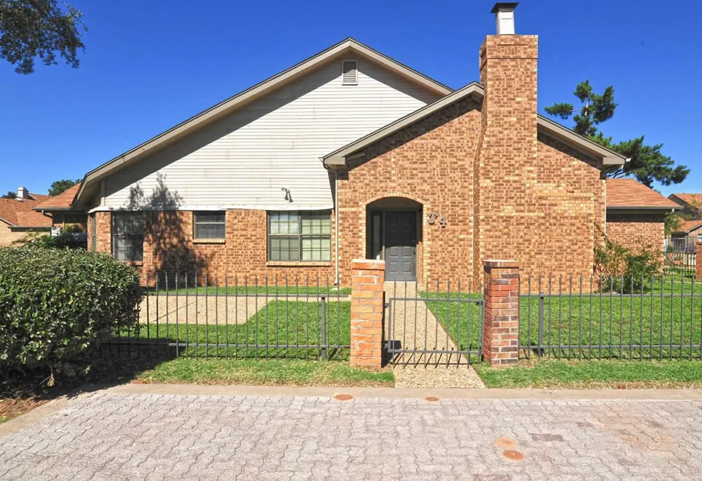 a house with a fence in front of it
