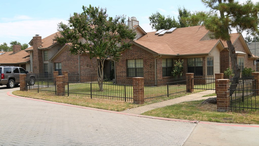 a house with a fence in front of it