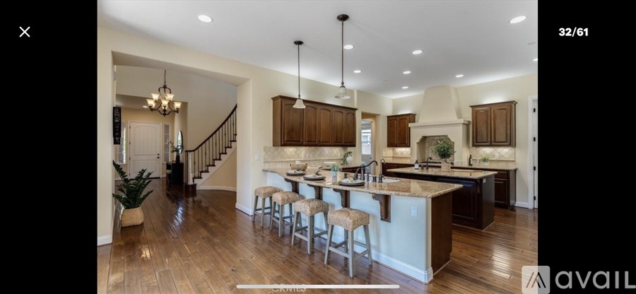 A modern kitchen with wooden cabinets and a central island.