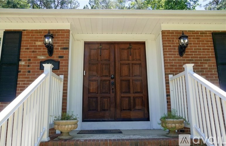 A house with a brown door and white railings.