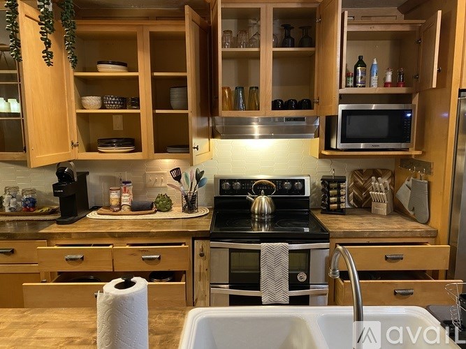 A kitchen with wooden cabinets and a white countertop.