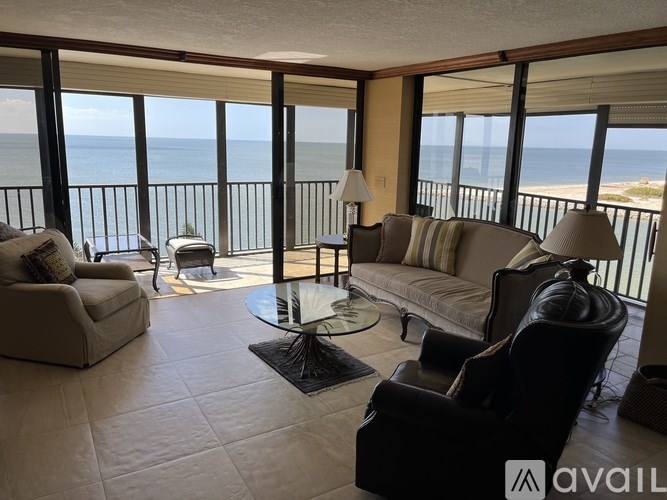 A living room with a view of the ocean.