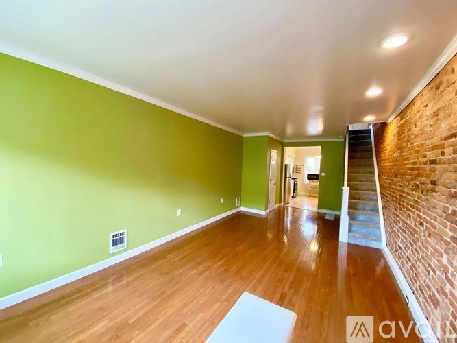 A room with green walls and wooden floors.