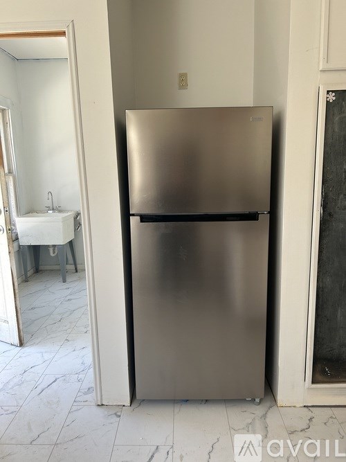 A stainless steel refrigerator in a kitchen.
