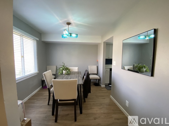 A dining room with a table and chairs.