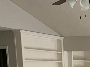an empty living room with a wood floor and a closet