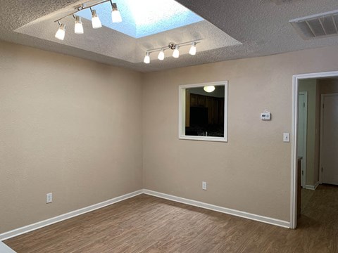 an empty room with a mirror and lights on the ceiling