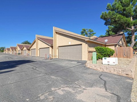 a row of houses with garages on the side of a street