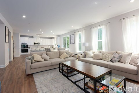 A modern living room with a large sectional sofa and a coffee table.