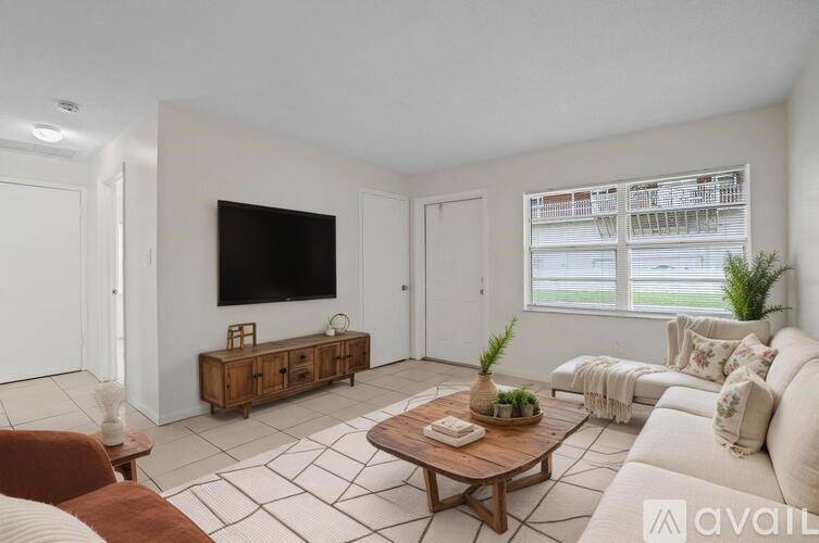 A room with white walls and a tiled floor with two windows.