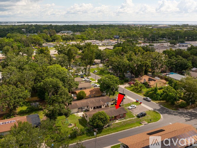 A red arrow is pointing to a building in a suburban area.