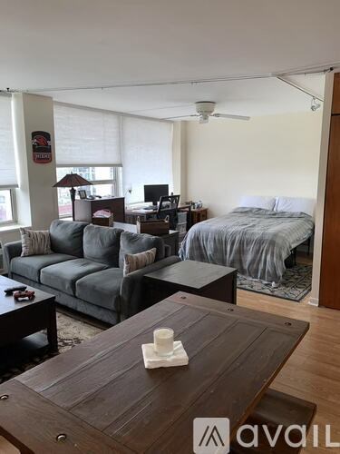 A living room with a grey couch and a wooden table.