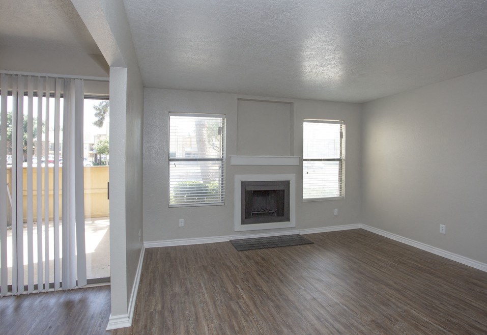 the living room of an empty house with a fireplace