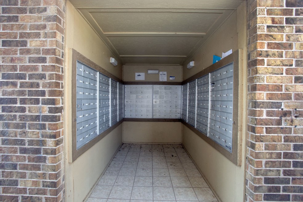 a locker room with rows of lockers on a brick wall