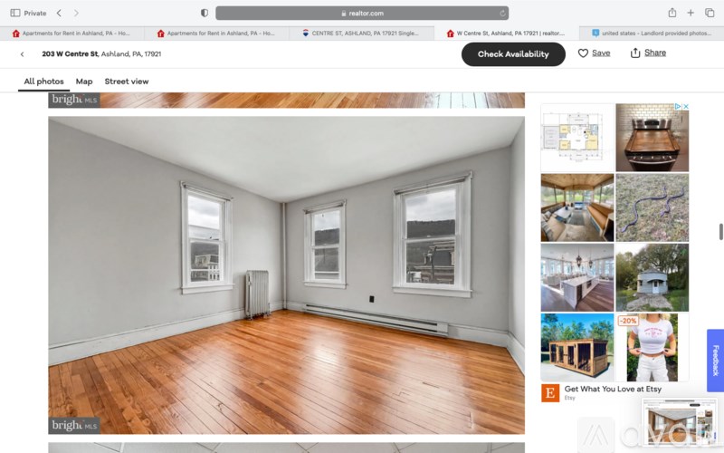 A webpage displays a room with wooden flooring and two windows.