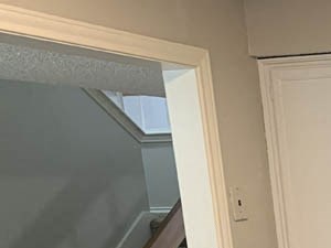 a kitchen with white cabinets and a sink and a window