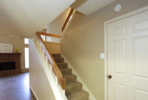 a staircase in a home with a white door