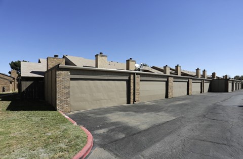 the front of a house with a driveway and a garage door