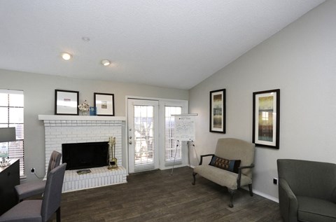a living room with a fireplace and a sliding glass door