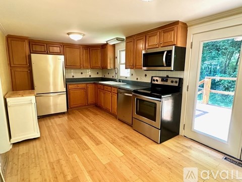 A kitchen with wooden cabinets and a white refrigerator.