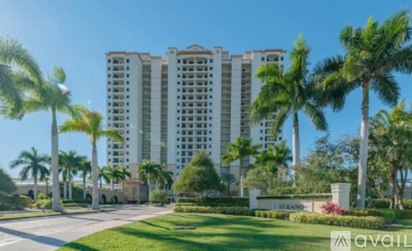 A tall white building with a sign that says "SERENDIP" in front of it.