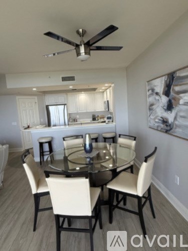 A dining room with a glass table and chairs.