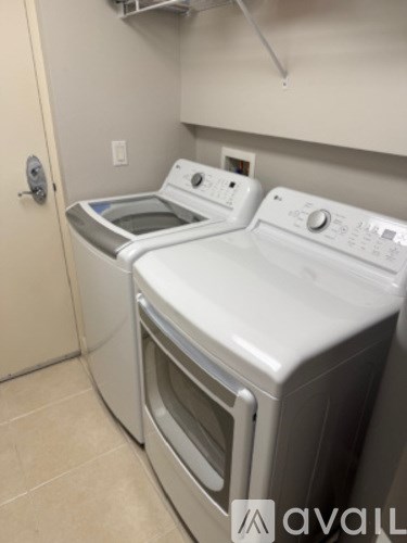Two front loading washing machines in a laundry room.