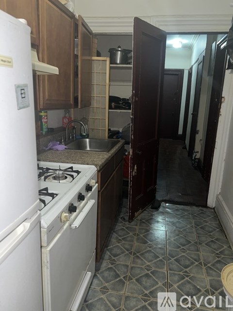 A kitchen with a white fridge and a white stove top.