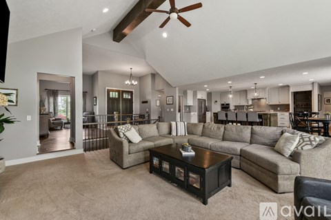 A living room with a grey couch and a black coffee table.