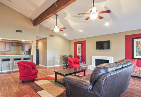 a living room with leather furniture and a fireplace