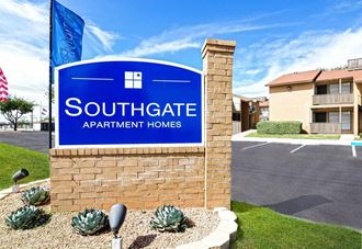 a sign for southgate apartment homes in front of a street