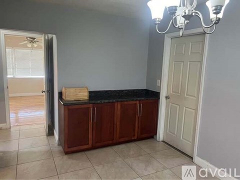 A kitchen area with a counter and cabinets.