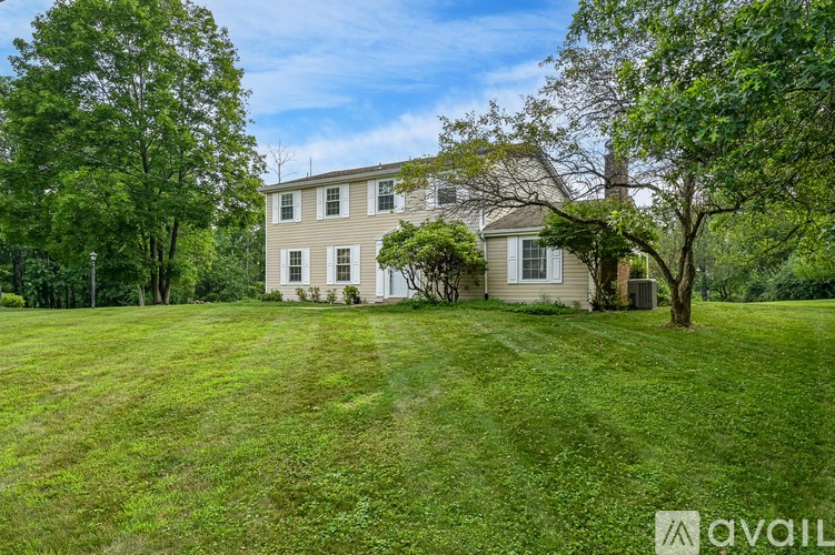 A large house with a lawn in front of it.
