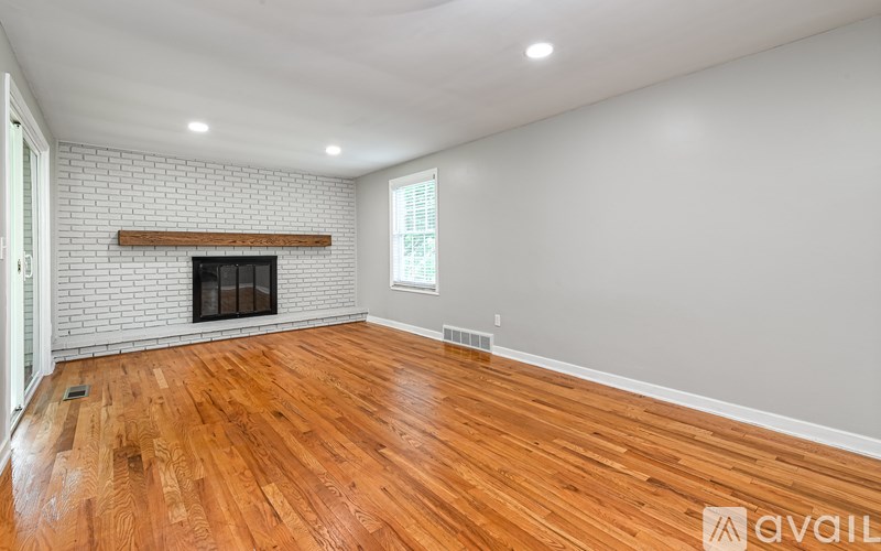 A room with a fireplace and wooden floors.