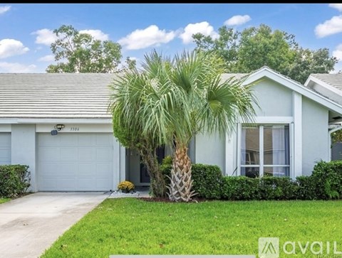 A house with a palm tree in front of it.