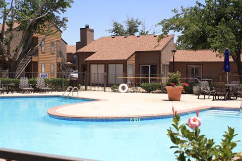 a swimming pool with houses in the background