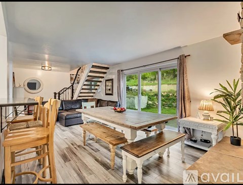 A living room with a wooden table and chairs.