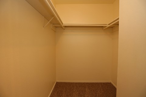 a small room with a white wall and a closet