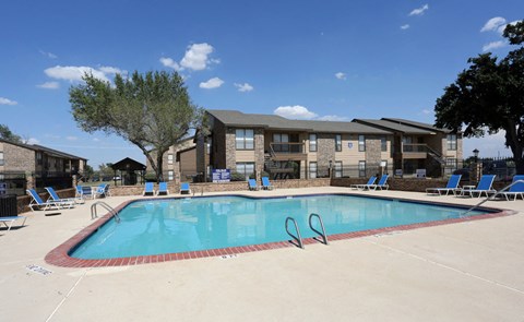 our apartments offer a swimming pool with chairs around it