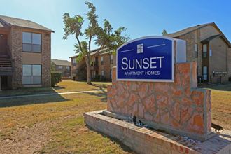 a sunset apartment building with a sunset apartments sign