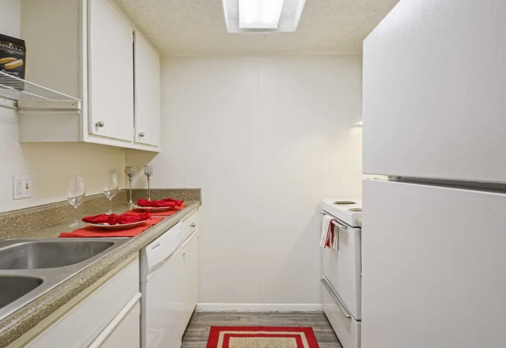 a kitchen with a sink and a refrigerator