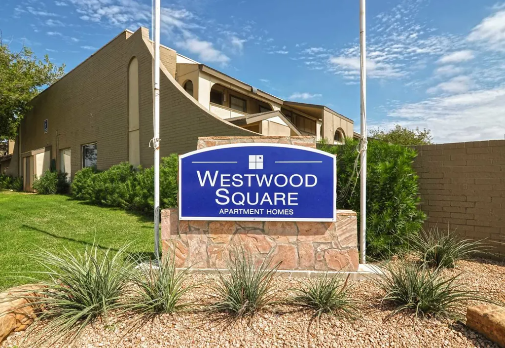 a blue westwood square sign in front of a building