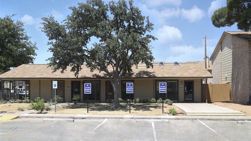 a building with signs in front of a tree