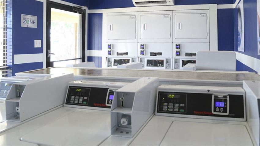 three microwaves in a counter in a room