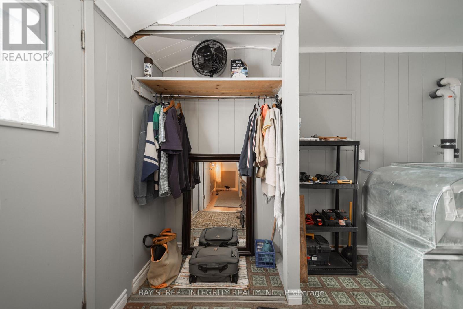 A bedroom with a bed, a closet, and a window.