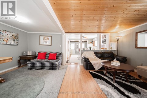 A living room with a black and white checkered couch and a wooden table.