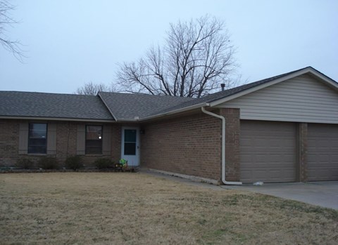 A house with a grey roof and a white door.